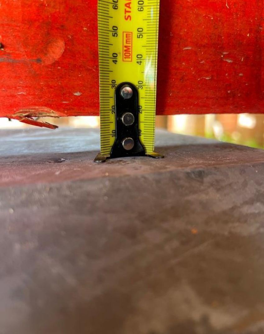 Tape measure showing a gap between the top of a brick pier and the timber bearer above