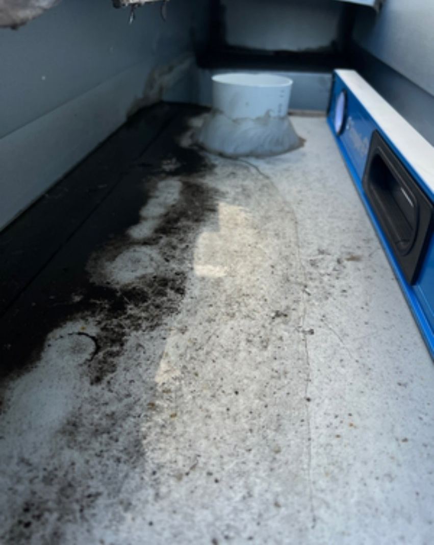 Box gutter with water staining and ponding marks leading to sump