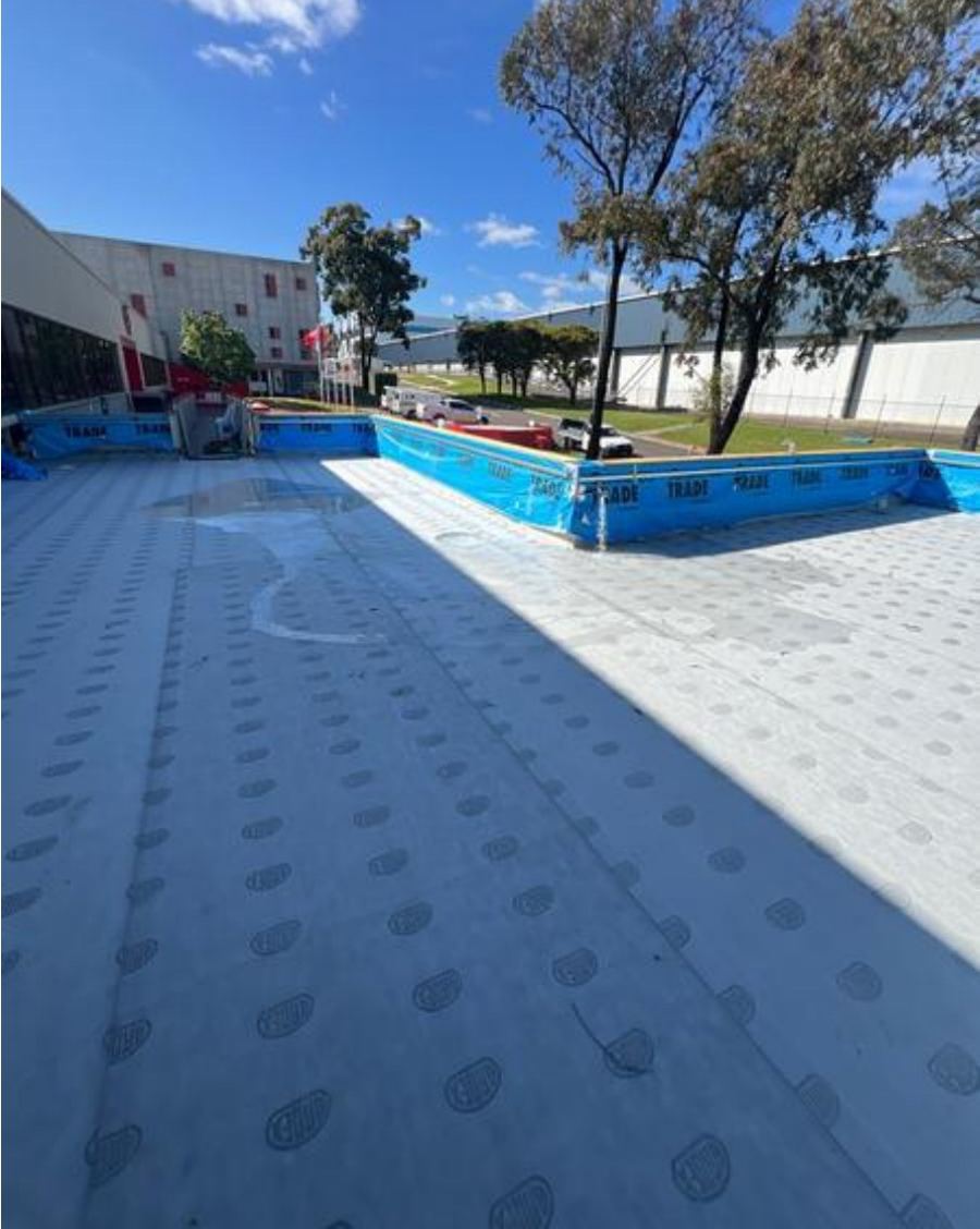 Balcony membrane with water beginning to pond at the start of a flood test