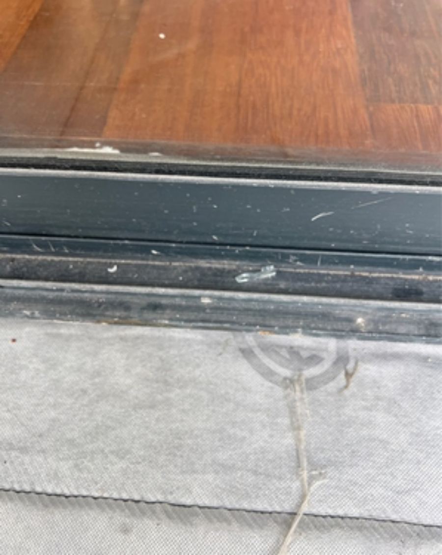 Sliding door threshold with metal waterstop angle and membrane terminated against it
