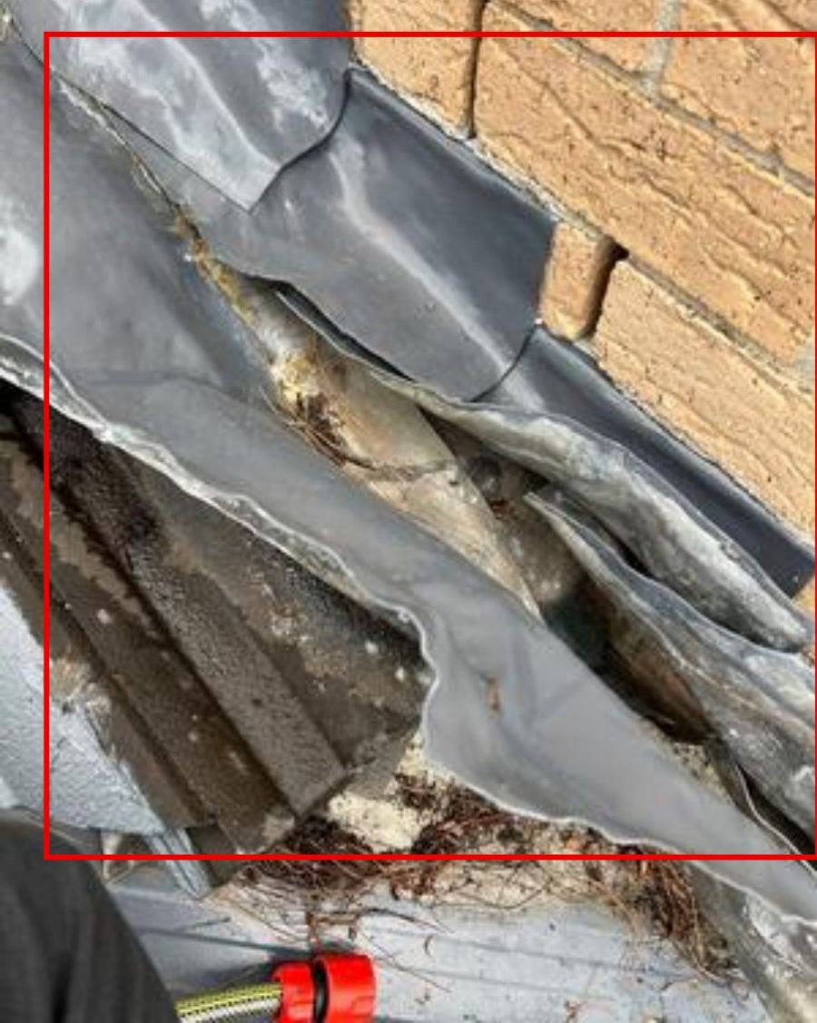 Roof flashing at a brick wall with the water entry point marked