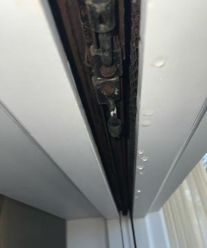 Water droplets at the top of an internal door frame